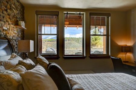 Large windows bathe the Primary Bedroom in warm natural light with stunning views.