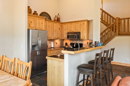 Fully equipped kitchen with stainless appliances and wood cabinets   - Spacious counter and bar seating perfect for shared meals   - Cook favorite recipes while enjoying rustic mountain charm