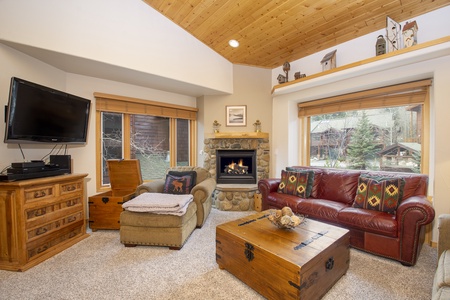 Large living room with Gas Fireplace and large windows bathing the space in natural light