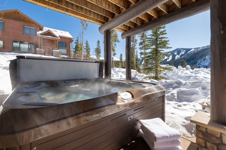 A ptivate hot tub under a deck with stunning views, perfect for relaxation after a day of adventuring