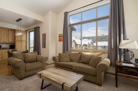 Spacious living area with high ceilings and large windows soaking the space in natural light