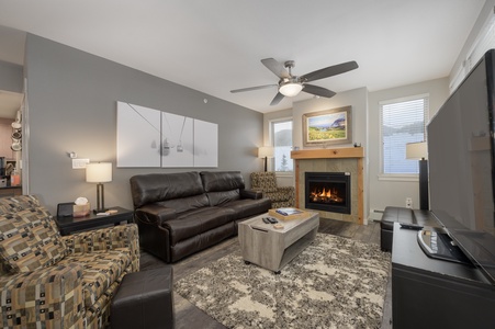 - Living room with leather sofa, armchair, and cozy fireplace   - Bright space with large windows and modern mountain décor   - Perfect spot to relax after skiing or hiking nearby trails