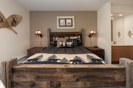 - Rustic bedroom with wooden bed frame design   - Cozy cabin style bedding with nature inspired decor   - Warm retreat for restful nights in the mountain
