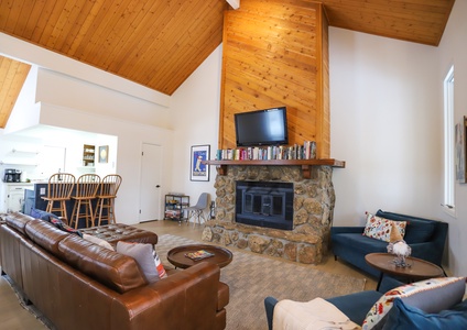 Brightly lit living room with a wood burning fireplace