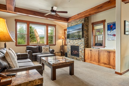Cozy living room with fireplace and natural light.