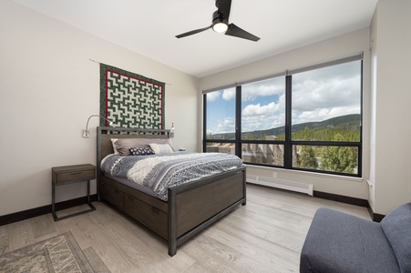 - Bedroom with panoramic windows overlooking mountain scenery   - Comfortable bed with soft linens for restful nights   - Peaceful setting with natural light and modern design