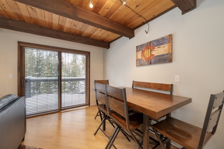 Spacious dining area with large sliding glass doors leading to an outdoor deck