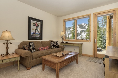 The basement den features an HDTV and seating for your guests, with large windows and views of the resort.