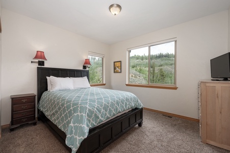 - Bedroom with queen bed and mountain view windows   - Comfortable setup with bright natural lighting   - Peaceful retreat perfect for restful sleep stay