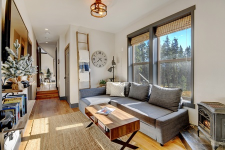 The Main House living space has large windows invite plenty sunshine into the room.