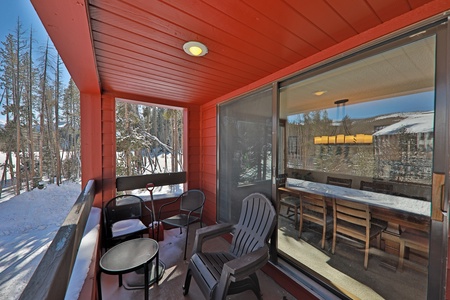 Covered patio with propane grill and outdoor seating