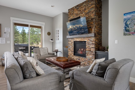 Comfortable living area featuring plush sofas and rustic fireplace   - Perfect place for family movie nights after skiing or snowboarding   - Inviting Colorado home designed for group gatherings and relaxation
