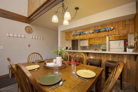 A cozy kitchen and dining area with wooden furniture.