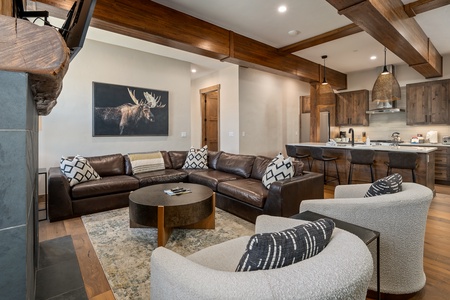 - Gather around the oversized leather sectional in this stylish open concept lounge - Moose art piece and wooden beams add a warm alpine lodge atmosphere - Pillows, throws, and cozy seating make this space ideal for movie nights or chats