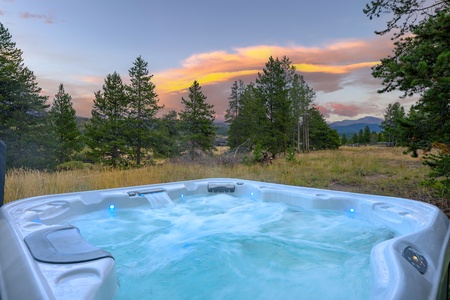 Private outdoor hot tub ideal for après ski relaxation in Colorado   - Covered patio with seating for outdoor dining and cozy evenings   - Relaxing amenity making mountain vacations truly unforgettable