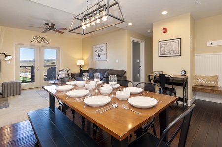 Dining area with a wooden table set for 8, perfect ambiance for unforgettable meals and conversation