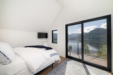 Primary bedroom with a queen bed, a private balcony, and beautiful views!