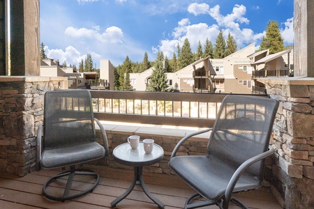 - Private balcony with two swivel chairs and morning sun perfect for fresh coffee - Blue skies and treetop views set the mood for peaceful outdoor moments - Cozy setting for quiet talks afternoon reads or a sip under the stars
