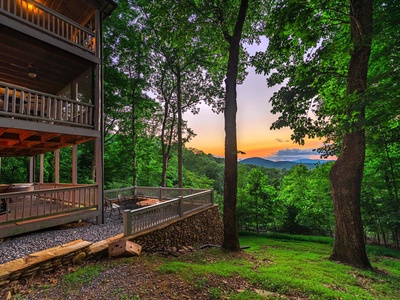 Aska Bliss- Side view of the cabin with the deck levels and mountain views