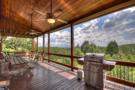 Above Ravens Ridge- Entry level deck area with a grill