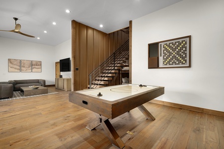 The Seven Hills - Lower Level Game Room Features a Wet Bar, Air Hockey Table, and TV