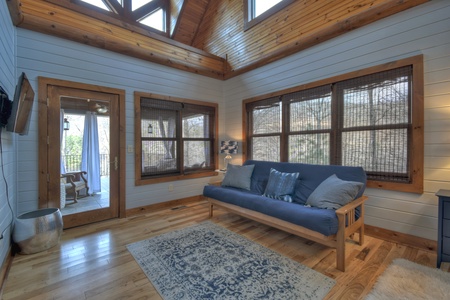 River Lodge- Master suite seating with a TV and deck access