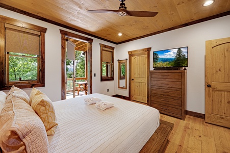 Mountain Echoes- Bedroom  with deck access a dresser and TV