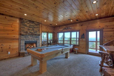 Grand Bluff Retreat- Recreation room with a fireplace and deck access