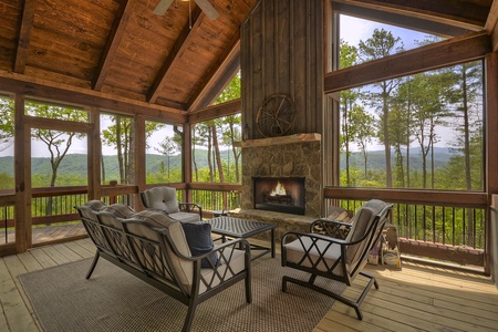 Vista Rustica- Outdoor seating and fireplace on the screened in porch