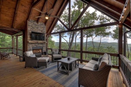 A Perfect Day- Entry level deck space with a fireplace and outdoor seating