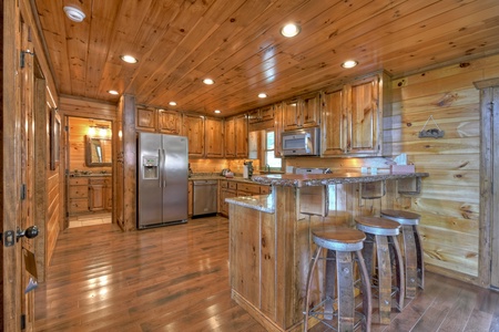 Grand Bluff Retreat- Kitchen area with an island & bar stool seating