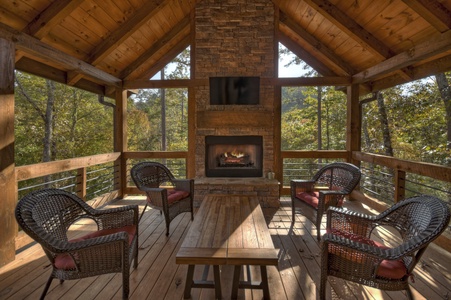 Cedar Ridge - Entry level deck with a fireplace and outdoor seating