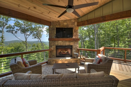 New Heights- Outdoor fireplace and seating area with a TV