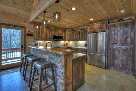 Whisky Creek Retreat- Kitchen area with a bar island and stools