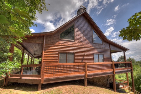 Above Ravens Ridge- Exterior view of the cabin with a wrap around deck