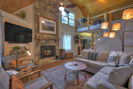 Sipping Rise- Entry level living area with modern furnishings and a fireplace