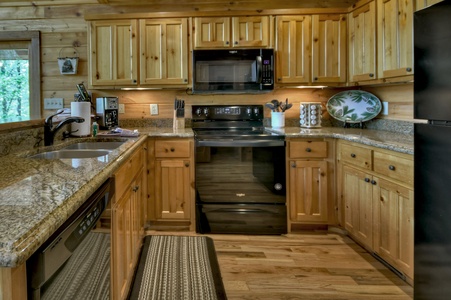 Aska Lodge- Full kitchen with rustic cabinet design and appliances