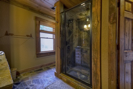 Reel Creek Lodge- Large walk in stone shower perspective view