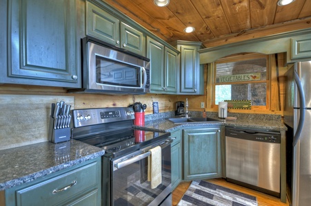 View From The Top- Kitchen with rustic cabinets and appliances