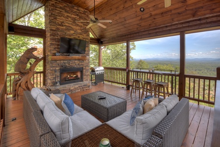 Grand Bluff Retreat- Entry level outdoor lounge area with fireplace