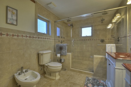 Family Farmhouse- Master suite bathroom with a walk in tile shower