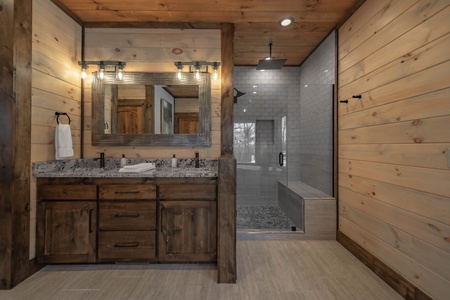 The Ridgeline Retreat- Main level master bathroom with a walk in shower and double vanity