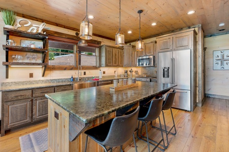 Mountain Echoes- Kitchen area with an island and stools