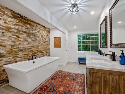 Gleesome Inn- Master bathroom with double vanity sink and a soaker tub