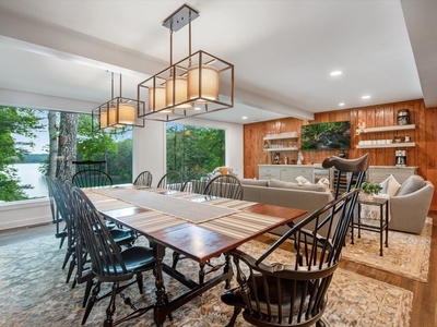 Gleesome Inn- Dining area with hanging light fixtures and living room access