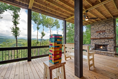 Feather & Fawn Lodge- Lower level deck fireplace and janga game