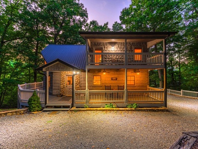 Aska Bliss- Evening driveway view of the cabin and it's interior lights