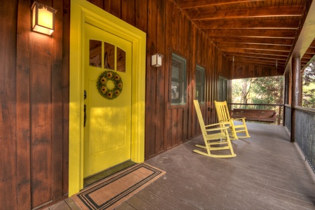 River Lodge- Front entrance from the porch with outdoor rocking chairs