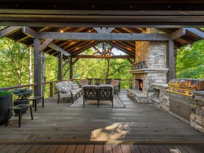 River Joy Lodge- Entry Level Deck Covered Fireplace Seating Area