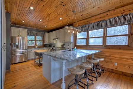 River Lodge- Kitchen view with a large island stool seating
